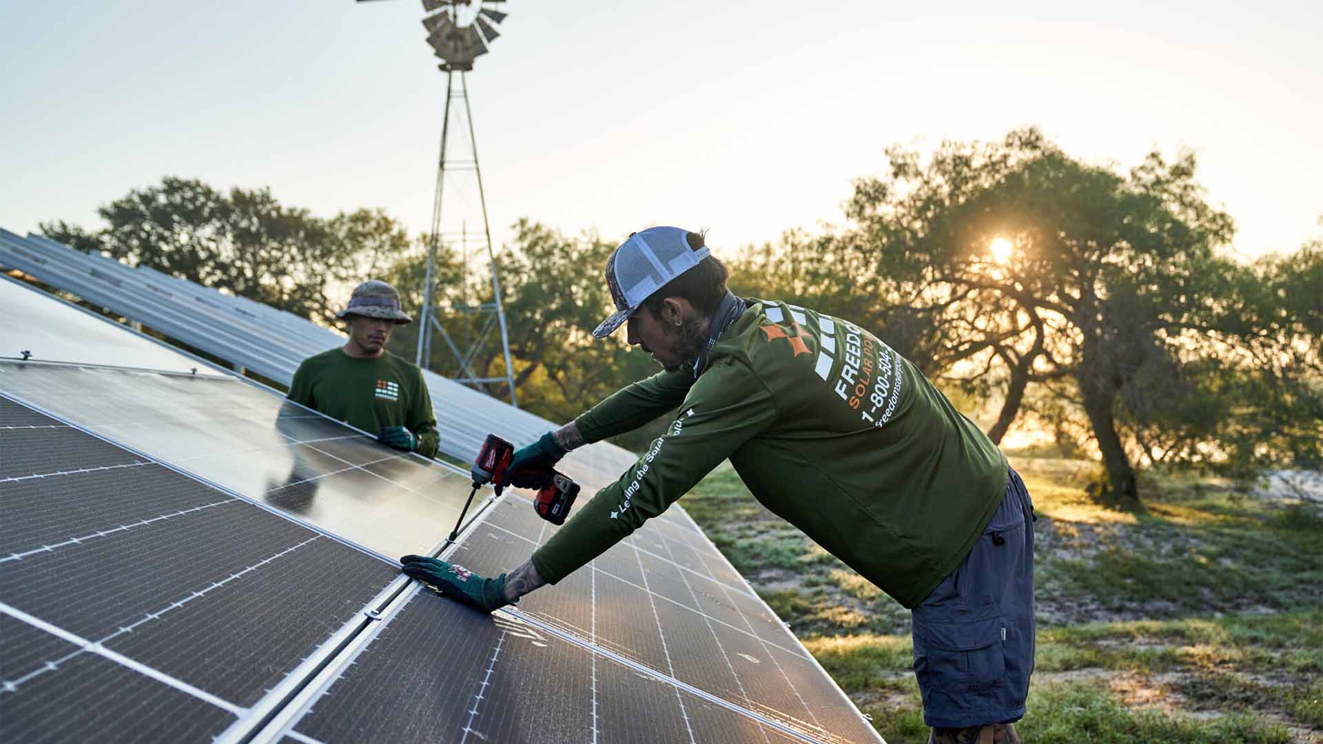 Two men are working on a solar panel