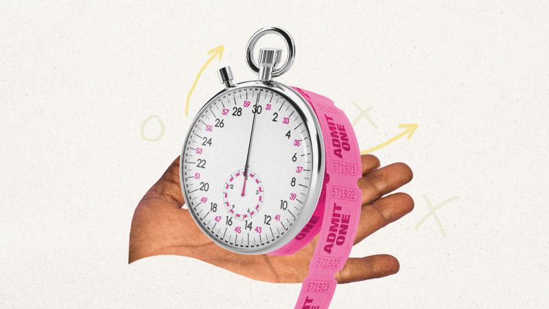 a hand holding a stopwatch with a pink ribbon around it